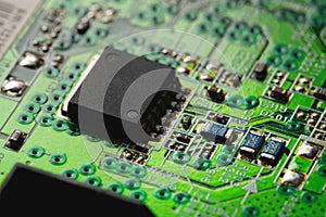 Electronic circuit close-up microchip on a green microcircuit with elements of transistors and strapping