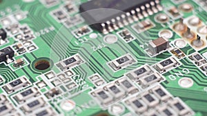 Electronic components on a computer board. Green circuit board background of PC computer motherboard