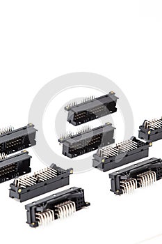 Electronic Components Concepts. Closeup of Rows of Long Angular PCB Connectors or Terminal Blocks Placed in Lines On White