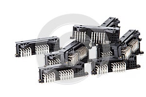 Electronic Components Concepts. Closeup of Rows of Long Angular PCB Connectors or Terminal Blocks Placed Randomly On White