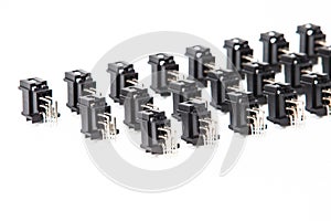 Electronic Components Concepts. Closeup of Rows of Short Angular PCB Connectors or Terminal Blocks Placed in Lines On White