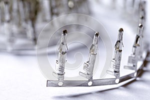 Electronic Concepts. Closeup of Line of Silver Tinned External PCB Angular Connectors Over White Background