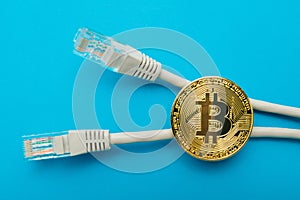 Electronic crypto currency bitcoin and internet connectors are isolated on a blue background