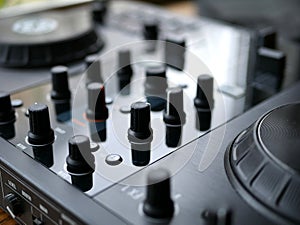 Electronic dance music digital audio dj gear with knobs, faders, at an edm festival.