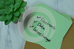 Electronic Data Interchange write on sticky notes isolated on Wooden Table