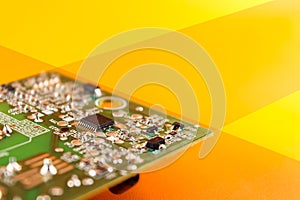 electronic device, green circuit or motherboard on orange yellow background