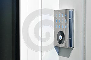 Electronic digital door lock on white office wall close up