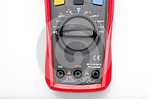 Electronic digital multimeter isolated on white with probes. Digital multimeter with red and black leads. Electronic multimeter is