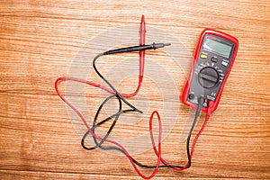 Electronic digital multimeter isolated on white with probes. Digital multimeter with red and black leads. Electronic multimeter is