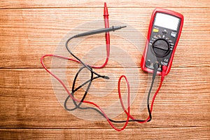 Electronic digital multimeter isolated on white with probes. Digital multimeter with red and black leads. Electronic multimeter is