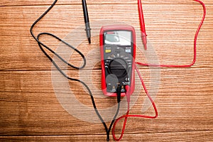 Electronic digital multimeter isolated on white with probes. Digital multimeter with red and black leads. Electronic multimeter is