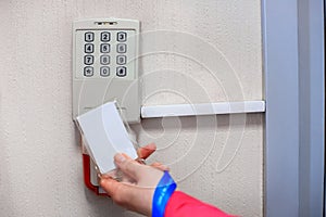 Electronic door lock, opening by security card. lady opening an electronic door lock by a security card