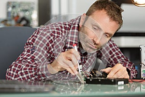 electronic engineer soldering iron and tweezers photo