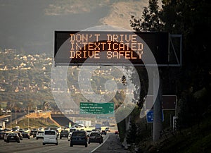 An electronic freeway sign advising against texting while driving.