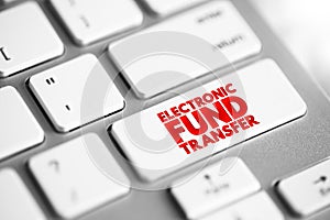 Electronic Fund Transfer is the electronic transfer of money from one bank account to another, text concept button on keyboard