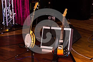 Electronic Guitars before the concert stand on the floor speaker and microphone