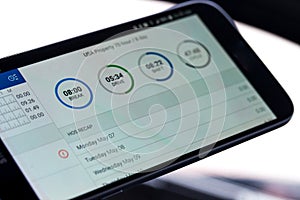 Electronic logging device for trucking industry with hours of service displayed on smartphone screen