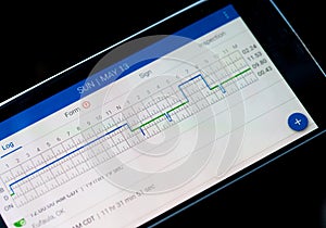 Electronic logging device for trucking industry with hours of service displayed on smartphone screen