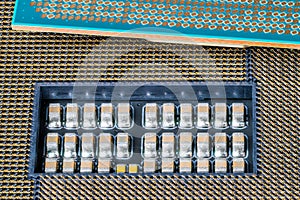 Electronic micro components in computer mainboard socket and a green processor detail