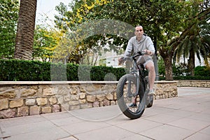 Electronic mobility. People. Active, healthy and sustainable lifestyle concept. Handsome sportsman riding an electric