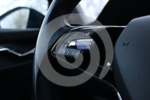 Electronic mode switch buttons on the multifunction steering wheel of a modern car