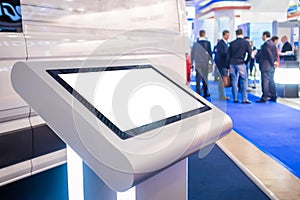 Electronic multimedia tablet kiosk with blank white display at exhibition