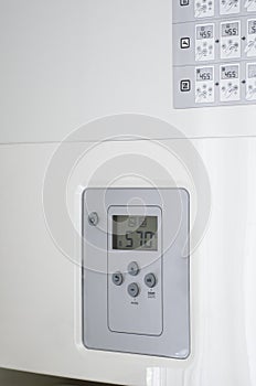 Electronic panel of a white electric water heater.