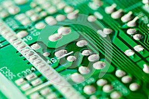 Electronic printed circuit board green with copper tracks, macro close-up, bokeh effect
