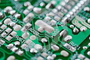 Electronic printed circuit board green with copper tracks, macro close-up, selective focus