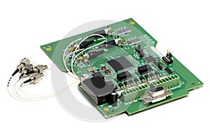 Electronic printed circuit board with optic connectors attached and other components, front side, angled view, isolated on white
