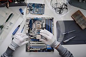 Electronic Repairman Working on CPU Installation Into Computer