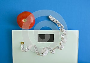 Electronic scales, centimeter tape and tomato