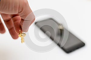 Electronic security and data protection concept. Mobile phone and key lock