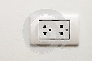 Electronic socket on white wall
