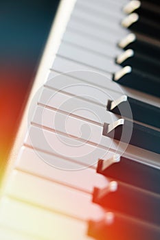 Electronic synthesizer piano keyboard in the sun`s rays macro