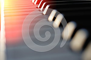 Electronic synthesizer piano keyboard in the sun`s rays macro