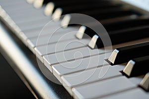 Electronic synthesizer piano keyboard in the sun`s rays macro