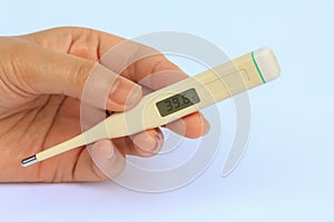 Electronic Termometer on hand. photo