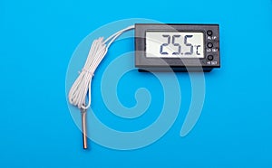 electronic thermometer on a blue background
