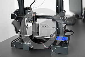 Electronic three dimensional plastic 3D printer during work in laboratory.