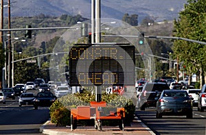 Electronic traffic sign stating Construction Ahead with traffic