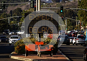 Electronic traffic sign stating Expect Delays with traffic photo