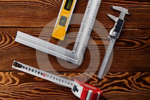 Electronic vernier caliper, wooden background