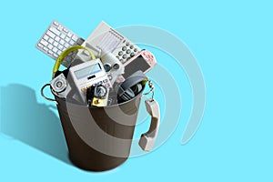 Electronic Waste broken or damage In Dustbin isolated on blue background and leave blank space above for text input, Reuse and