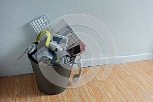 Electronic Waste broken or damage In Recycle bin in the room with white wall and leave blank space above for text input