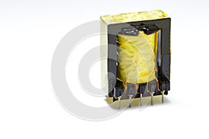 Electronics Concepts. Closeup Image of Powerful Alternative Current Voltage Transformer in Yellow Isolation Against White