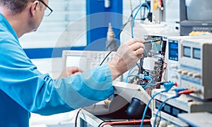 Electronics engineer troubleshooting defects in a hardware product photo