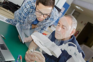 Electronics engineer observing product