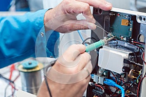 Electronics engineer troubleshooting defects in a hardware product photo