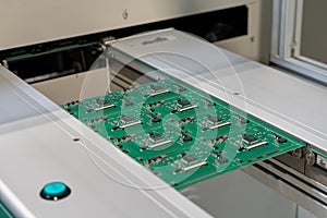 Electronics PCB board on the assembly SMT line conveyor